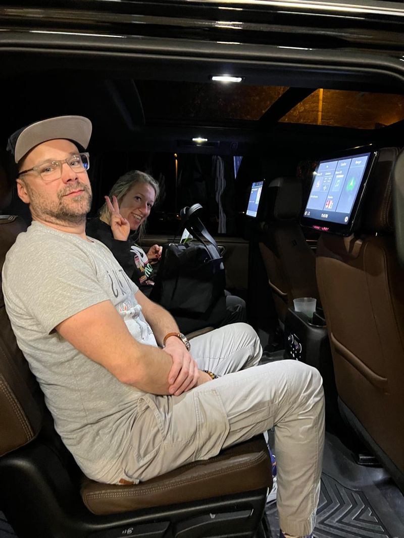 Guests in the rear seats of a Layla SUV at night