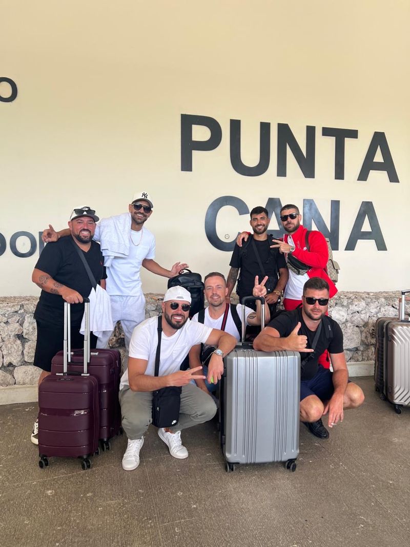Group of seven guests with luggage at Punta Cana airport